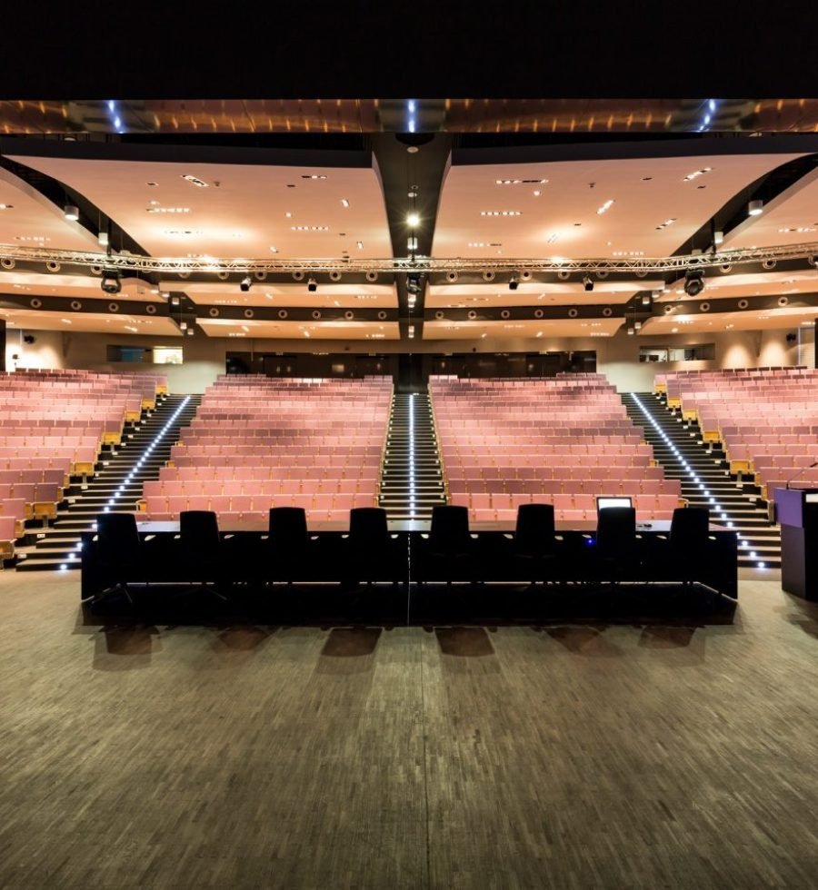 auditorium-with-long-table-and-podium-e1608772711486.jpg